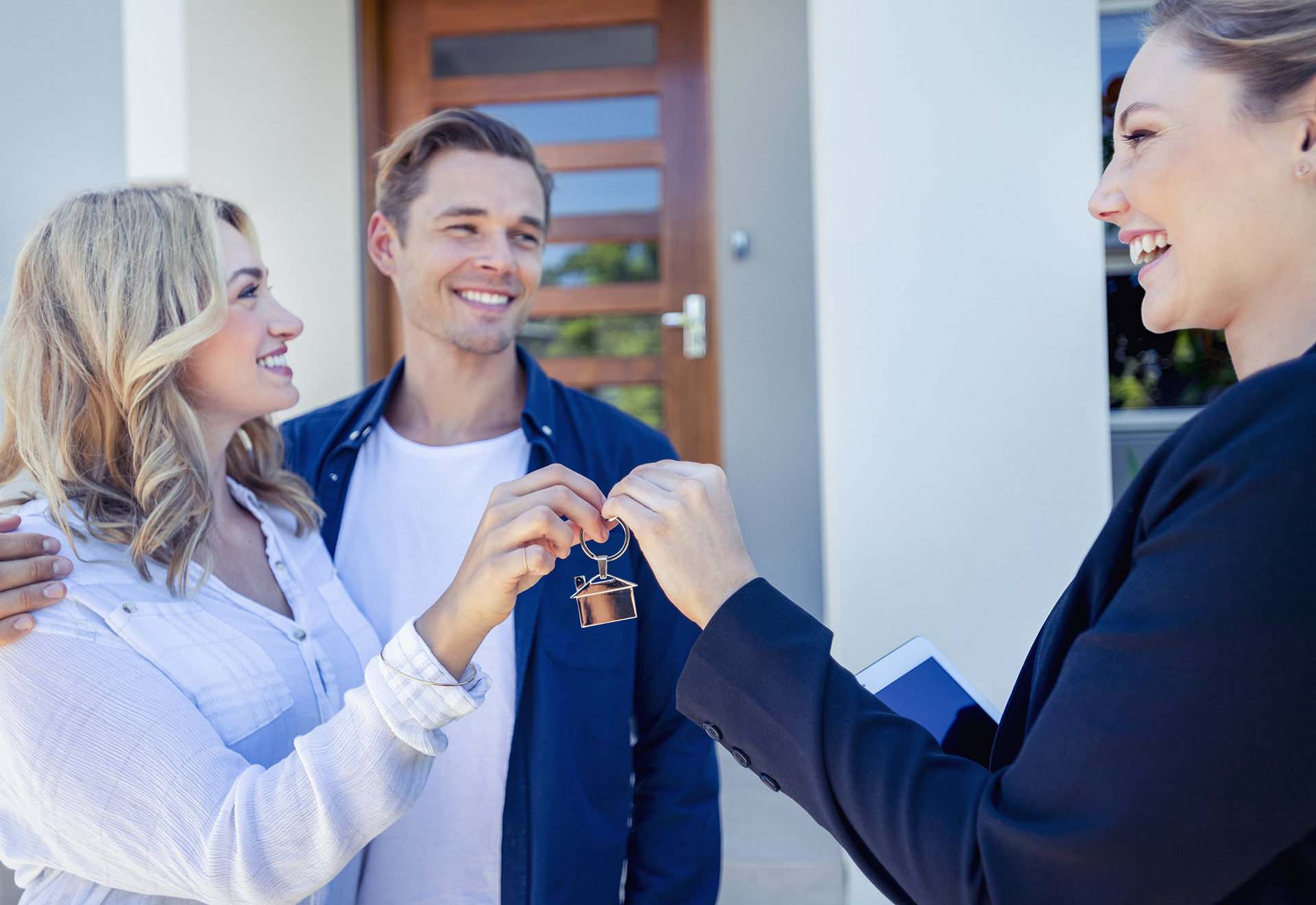 Handing couple house keys.